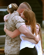 Returning Solider Hugging
 Family